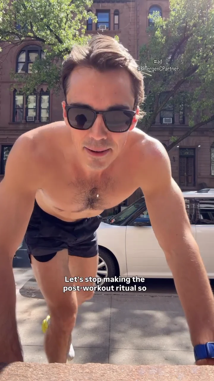 Sam Leicht in sunglasses stretching against a stoop on a sunny New York street after a run