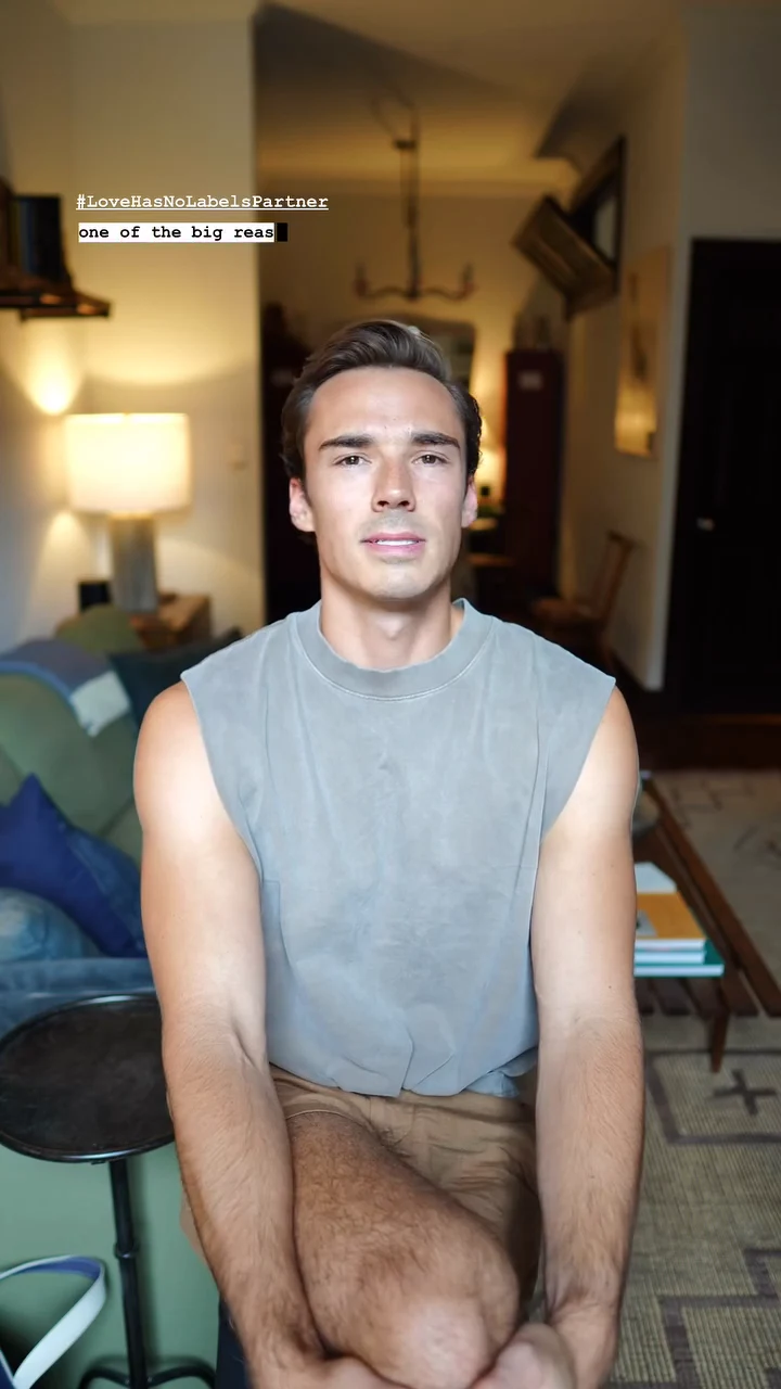 Sam Leicht seated in a warmly lit living room, speaking to camera for Love Has No Labels
