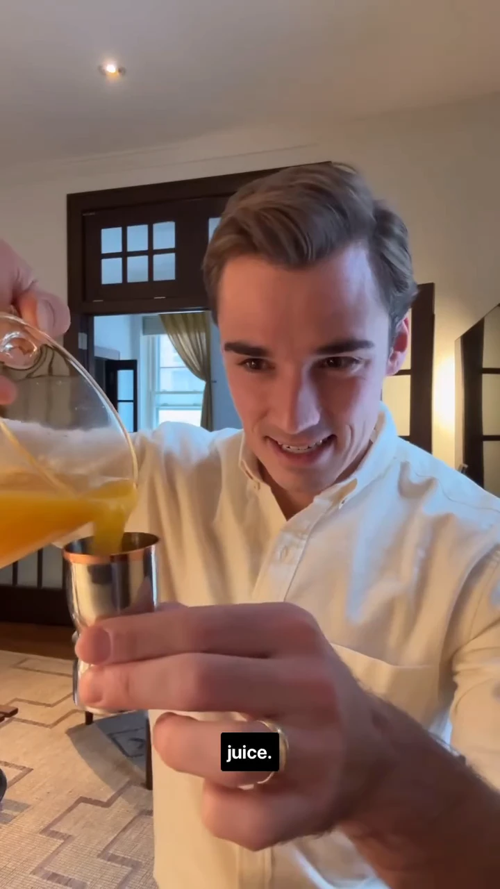 Sam Leicht in a white shirt pouring orange juice into a jigger for an Emergen-C mocktail