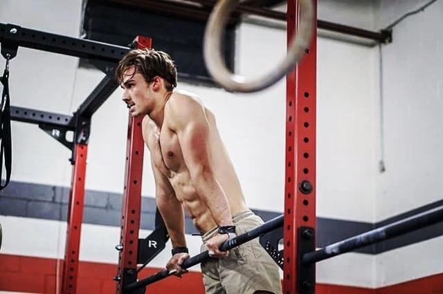 Sam Leicht doing ring work in a CrossFit gym