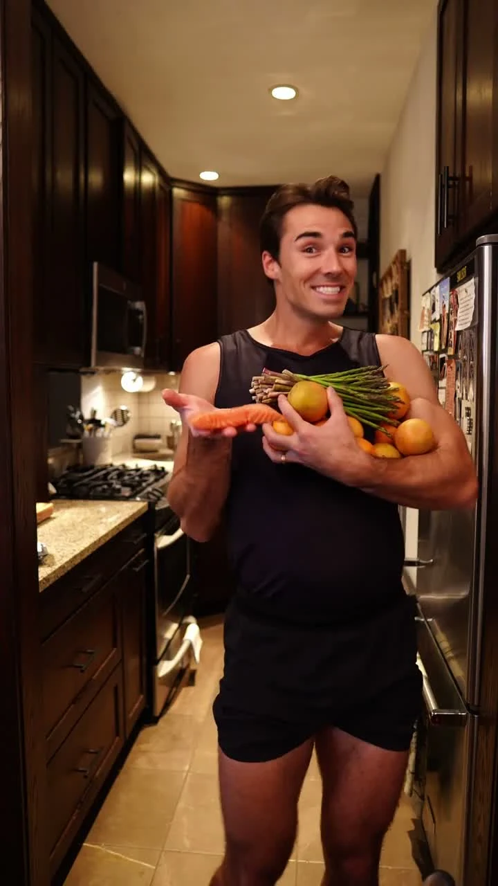Sam Leicht holding an armful of oranges, asparagus and salmon in an Emergen-C social video